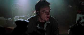 Movie still from “The Score” (2001), directed by Frank Oz – A person wearing a headset; Close Up shot, Low angle