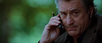 Movie still from “The Score” (2001), directed by Frank Oz – An older man talking on a cell phone; Close Up shot, Low angle