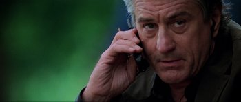 Movie still from “The Score” (2001), directed by Frank Oz – An older man talking on a cell phone; Close Up shot, Low angle