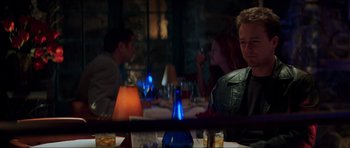 Movie still from “The Score” (2001), directed by Frank Oz – A group of people sitting at a table in a restaurant; Medium shot, Over the shoulder angle