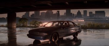 Movie still from “The Score” (2001), directed by Frank Oz – A car parked on the side of the road in the rain; Wide shot, Low angle