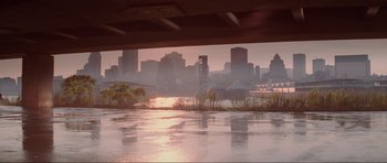Movie still from “The Score” (2001), directed by Frank Oz – A view of a city from under a bridge at sunset; Extreme Wide shot, Low angle