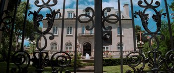 Movie still from “The Score” (2001), directed by Frank Oz – A view through a gate of a large mansion; Extreme Wide shot, Low angle