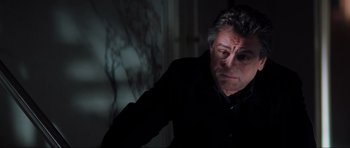 Movie still from “The Score” (2001), directed by Frank Oz – A person wearing a black shirt; Close Up shot, Low angle