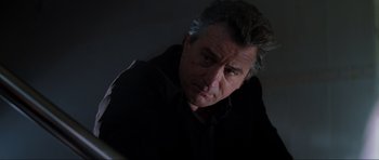 Movie still from “The Score” (2001), directed by Frank Oz – A person wearing a black shirt; Close Up shot, Low angle