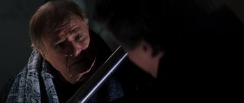 Movie still from “The Score” (2001), directed by Frank Oz – An older man looking at himself in the mirror; Close Up shot, Over the shoulder angle