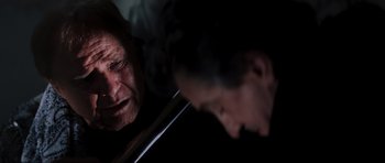 Movie still from “The Score” (2001), directed by Frank Oz – An older man looking in the mirror and crying; Close Up shot, Over the shoulder angle