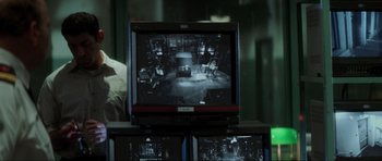 Movie still from “The Score” (2001), directed by Frank Oz – An image on a television screen; Medium shot, Over the shoulder angle