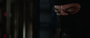 Movie still from “The Score” (2001), directed by Frank Oz – A person wearing a black mask; Close Up shot, Over the shoulder angle