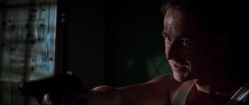 Movie still from “The Score” (2001), directed by Frank Oz – A shirtless man is looking at the camera; Close Up shot, Low angle