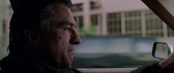 Movie still from “The Score” (2001), directed by Frank Oz – A person sitting in a car; Close Up shot, Low angle