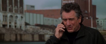 Movie still from “The Score” (2001), directed by Frank Oz – A person talking on a cell phone; Close Up shot, Low angle