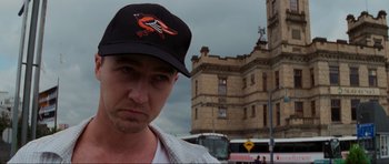 Movie still from “The Score” (2001), directed by Frank Oz – A person wearing a baseball cap; Close Up shot, Low angle