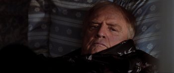 Movie still from “The Score” (2001), directed by Frank Oz – An older man is sitting in a chair; Close Up shot, Low angle