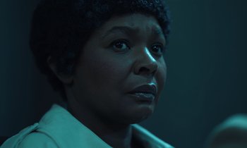 Movie still from “The Silent Twins” (2022), directed by Agnieszka Smoczynska – An older black woman looking at the camera; Close Up shot, Low angle