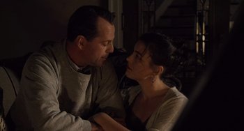 Movie still from “The Sixth Sense” (1999), directed by M. Night Shyamalan – A man and a woman sitting on a couch looking at one another; Close Up shot, Over the shoulder angle