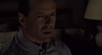 Movie still from “The Sixth Sense” (1999), directed by M. Night Shyamalan – A person wearing a gray shirt; Close Up shot, Over the shoulder angle