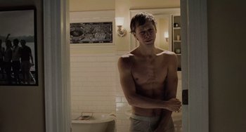 Movie still from “The Sixth Sense” (1999), directed by M. Night Shyamalan – A man standing in a bathroom in front of a mirror; Medium shot, High angle