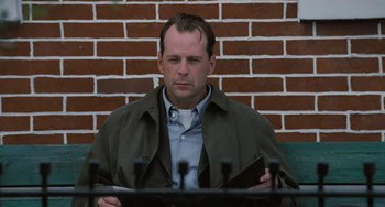 Movie still from “The Sixth Sense” (1999), directed by M. Night Shyamalan – A man sitting in front of microphones in front of a brick wall; Close Up shot, Low angle