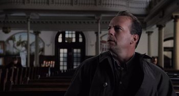 Movie still from “The Sixth Sense” (1999), directed by M. Night Shyamalan – A man in a black jacket is looking to his left; Close Up shot, Low angle