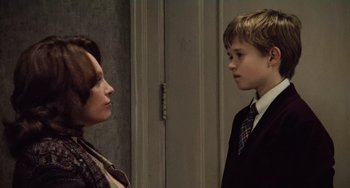 Movie still from “The Sixth Sense” (1999), directed by M. Night Shyamalan – A woman and a young boy are facing each other; Medium shot, Over the shoulder angle