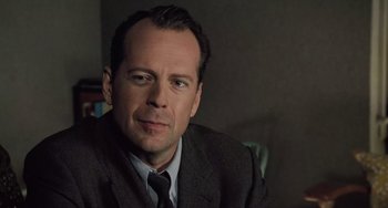 Movie still from “The Sixth Sense” (1999), directed by M. Night Shyamalan – A person wearing a suit and tie; Close Up shot, Over the shoulder angle