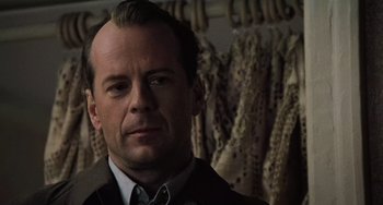 Movie still from “The Sixth Sense” (1999), directed by M. Night Shyamalan – A person wearing a suit and tie; Close Up shot, Over the shoulder angle