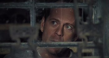 Movie still from “The Sixth Sense” (1999), directed by M. Night Shyamalan – A person looking through a fence; Close Up shot, Over the shoulder angle