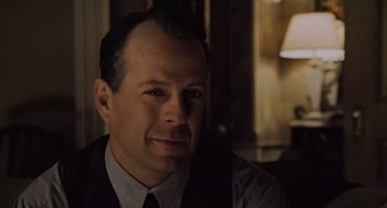 Movie still from “The Sixth Sense” (1999), directed by M. Night Shyamalan – A person wearing a suit and tie; Close Up shot, Over the shoulder angle