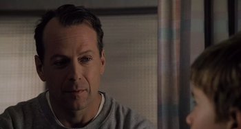 Movie still from “The Sixth Sense” (1999), directed by M. Night Shyamalan – A person sitting in front of a window; Close Up shot, Over the shoulder angle