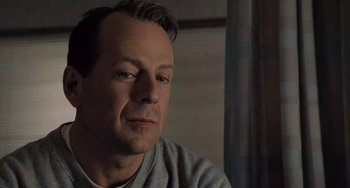 Movie still from “The Sixth Sense” (1999), directed by M. Night Shyamalan – A person sitting in front of a window; Close Up shot, Low angle