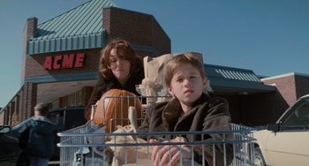 Movie still from “The Sixth Sense” (1999), directed by M. Night Shyamalan – A woman and a child in a shopping cart; Wide shot, Low angle