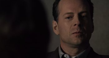 Movie still from “The Sixth Sense” (1999), directed by M. Night Shyamalan – A person wearing a suit and tie; Close Up shot, Over the shoulder angle