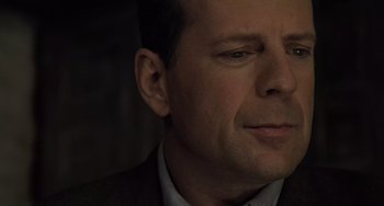 Movie still from “The Sixth Sense” (1999), directed by M. Night Shyamalan – A person wearing a suit and tie; Close Up shot, Low angle