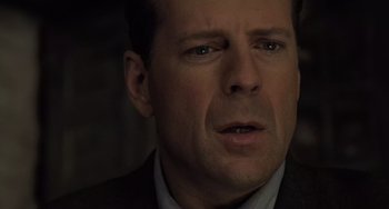 Movie still from “The Sixth Sense” (1999), directed by M. Night Shyamalan – A person wearing a suit and tie; Close Up shot, Low angle