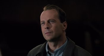Movie still from “The Sixth Sense” (1999), directed by M. Night Shyamalan – A person wearing a jacket looking to his left; Close Up shot, Low angle