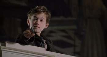 Movie still from “The Sixth Sense” (1999), directed by M. Night Shyamalan – A young boy holding a pen in his hand; Close Up shot, High angle