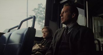 Movie still from “The Sixth Sense” (1999), directed by M. Night Shyamalan – A man and a boy are sitting on a bus; Medium shot, Over the shoulder angle