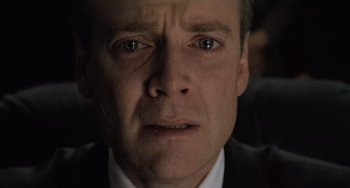 Movie still from “The Sixth Sense” (1999), directed by M. Night Shyamalan – A person wearing a suit and tie; Close Up shot, High angle