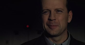 Movie still from “The Sixth Sense” (1999), directed by M. Night Shyamalan – A person wearing a suit and tie; Close Up shot, Over the shoulder angle