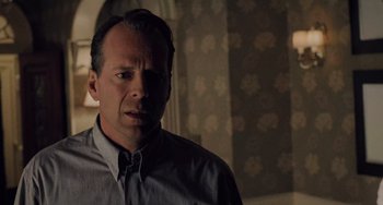 Movie still from “The Sixth Sense” (1999), directed by M. Night Shyamalan – A person wearing a dress shirt; Close Up shot, Over the shoulder angle