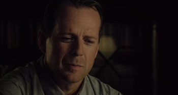 Movie still from “The Sixth Sense” (1999), directed by M. Night Shyamalan – A person with his eyes closed; Close Up shot, Over the shoulder angle