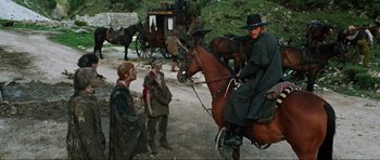 Movie still from “The Specialists” (1969), directed by Sergio Corbucci – A man on a horse is sitting on the ground; Wide shot, Over the shoulder angle