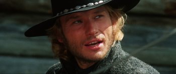 Movie still from “The Specialists” (1969), directed by Sergio Corbucci – A person wearing a cowboy hat; Close Up shot, Over the shoulder angle
