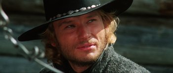 Movie still from “The Specialists” (1969), directed by Sergio Corbucci – A person wearing a cowboy hat; Close Up shot, Over the shoulder angle