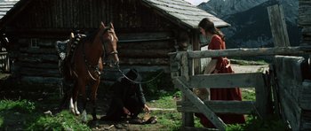 Movie still from “The Specialists” (1969), directed by Sergio Corbucci – A man and a woman standing next to a brown horse; Wide shot, High angle