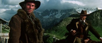 Movie still from “The Specialists” (1969), directed by Sergio Corbucci – A man in a cowboy hat standing next to another man in a cowboy hat; Medium shot, Low angle