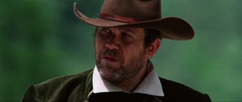 Movie still from “The Specialists” (1969), directed by Sergio Corbucci – A person wearing a cowboy hat; Close Up shot, Low angle