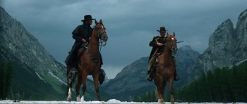 Movie still from “The Specialists” (1969), directed by Sergio Corbucci – A couple of men riding on the backs of horses; Wide shot, Low angle