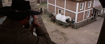 Movie still from “The Specialists” (1969), directed by Sergio Corbucci – A man taking a picture of a horse drawn carriage; Wide shot, High angle
